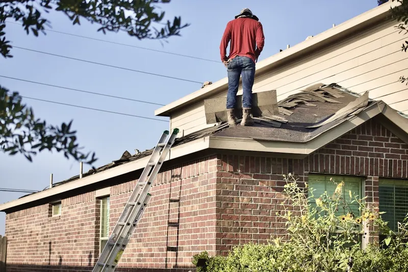 Professional roofer working on a residential roof in Okahumpka